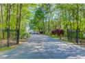 Gated driveway leading to the property, surrounded by lush trees at 700 Daniel Ellis Dr # 14206, Charleston, SC 29412