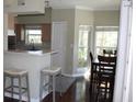 Open concept view of kitchen with breakfast bar and dining area featuring natural light at 700 Daniel Ellis Dr # 6107, Charleston, SC 29412