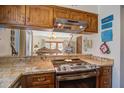 Stylish kitchen with stainless steel appliances, granite countertops, and wooden cabinets open to living area at 7000 Palmetto Dr # 5A, Isle of Palms, SC 29451
