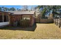 Brick house with a well-maintained backyard and mature landscaping at 105 Ford Ct, Summerville, SC 29483