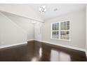 Cozy living room featuring hardwood floors, bright window, and staircase at 109 Arbor Oaks Dr, Summerville, SC 29485