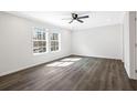 Bright bedroom featuring wood-look flooring, a modern ceiling fan, and plenty of natural light at 1326 Black Tom Rd, Moncks Corner, SC 29461