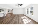 A sunlit living area with modern floors, a sleek ceiling fan, and a seamless open floor plan at 1326 Black Tom Rd, Moncks Corner, SC 29461