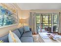Relaxing living room showcasing cozy seating, natural light and balcony access with nature views at 1407 Shipwatch Rd, Kiawah Island, SC 29455