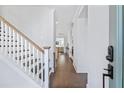 Inviting foyer with hardwood floors, staircase, and view into the living spaces at 170 Callibluff Dr, Summerville, SC 29486