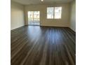 Bright living room featuring sleek flooring and large windows offering ample natural light at 1703 Scarlett Maple St, Summerville, SC 29486