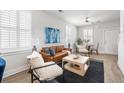 Spacious living room with ample seating, a ceiling fan, and lots of natural light at 2021 Arbutus Ave, North Charleston, SC 29405