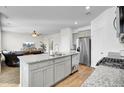 Open-concept kitchen boasts granite countertops, stainless steel appliances, and seamless flow to the living room at 211 Tall Grass Ct, Summerville, SC 29483