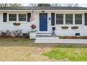 Charming home featuring a blue front door, white brick, an American flag, and flower boxes at 2137 Barbour Dr, Charleston, SC 29414