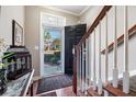 Inviting foyer with hardwood floors, staircase, and view of the outdoors through a storm door at 264 Fair Sailing Rd # 42, Mount Pleasant, SC 29466