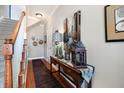 Elegant hallway with hardwood floors, console table, wall decor, and staircase at 264 Fair Sailing Rd # 42, Mount Pleasant, SC 29466