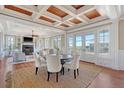 Elegant dining room area with a rustic wood ceiling, hardwood floors, and lots of natural light at 3030 Marshall Blvd, Sullivans Island, SC 29482