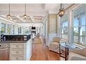 Open kitchen view to living room and backyard boasting a granite countertop and stainless steel appliances at 3030 Marshall Blvd, Sullivans Island, SC 29482