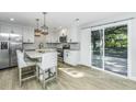 Updated kitchen with white cabinets, stainless steel appliances, and an island with seating at 318 Hollywood Dr, Charleston, SC 29407