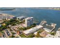 An aerial view showcases a waterfront condo building, a harbor with boats, and the Ravenel Bridge in the distance at 330 Concord St # 7 A, Charleston, SC 29401