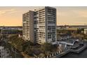 Condo building with balconies and a view of the city and waterfront, surrounded by trees at 330 Concord St # 7 A, Charleston, SC 29401