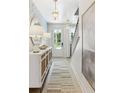 Stylish entryway with patterned wallpaper, modern lighting, and decorative accents at 351 Claret Cup Way, Charleston, SC 29414