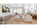 Bright and open living room with sectional sofa, large windows, and modern decor at 351 Claret Cup Way, Charleston, SC 29414
