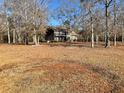 Beautiful two-story brick home with large front yard and mature trees, on a bright, sunny day at 388 Benton Farm Rd, Walterboro, SC 29488