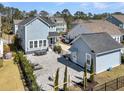 Spacious backyard featuring a stone patio, fire pit, lounge chairs, and fenced yard at 3920 Maidstone Dr, Mount Pleasant, SC 29466