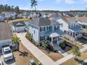 Two-story home with welcoming front porch, complimented by lush landscaping and a paved driveway at 3920 Maidstone Dr, Mount Pleasant, SC 29466