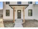 Close up of home's front door, featuring a modern design with wood columns and a decorative glass window at 397 Parkdale Dr, Charleston, SC 29414