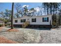 Inviting single-story home with wooden stairs, vinyl siding, dark shutters, and a gravel and pine straw yard at 421 Peacock Ln, Summerville, SC 29486