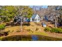 Beautiful view of the home from above, surrounded by lush landscaping and pond at 4333 Cloudmont Dr, Hollywood, SC 29449