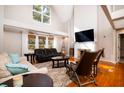 Bright living room with high ceilings, a fireplace, and large windows at 4333 Cloudmont Dr, Hollywood, SC 29449