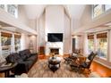 Bright open concept living room with vaulted ceiling, fireplace, and large windows at 4333 Cloudmont Dr, Hollywood, SC 29449