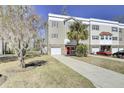 A charming multi-story townhome featuring a driveway and verdant landscaping at 4610 Palm View Cir, North Charleston, SC 29418