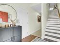 Inviting foyer with hardwood floors, staircase, and stylish decor at 4610 Palm View Cir, North Charleston, SC 29418