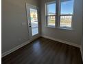 Room with wood-look floors, a door and double windows with exterior views at 5118 Double Eagle Lp, Summerville, SC 29485
