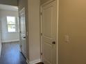 Hallway featuring wood-look floors, neutral paint and white doors at 5118 Double Eagle Lp, Summerville, SC 29485