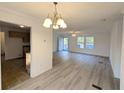 Spacious living room featuring bright light-colored floors, white walls, and views to the entry and kitchen at 5181 Dr Taylor Rd, Adams Run, SC 29426