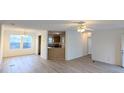 Bright living room featuring light-colored vinyl floors, white walls, and an open floor plan at 5181 Dr Taylor Rd, Adams Run, SC 29426