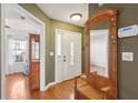 Entryway featuring hardwood floors, a coat rack and mirror, and a view into adjacent rooms at 5429 Roxbury Dr, North Charleston, SC 29418