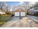 A spacious two-car garage is adjacent to a brick veneer exterior and a large concrete driveway at 5429 Roxbury Dr, North Charleston, SC 29418