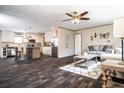 A spacious living room and kitchen with hardwood floors, neutral-toned walls, and modern ceiling fan at 632 Dennis Ridge Rd, Bonneau, SC 29431