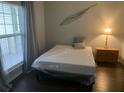 Bright bedroom with a bed covered in plastic wrap, next to a window and table at 700 Daniel Ellis Dr # 11202, Charleston, SC 29412