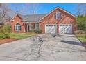 Lovely brick home with attached two car garage and a well manicured front yard at 8757 E Fairway Woods Dr, North Charleston, SC 29420