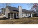 Rear exterior view featuring a screened-in porch and a spacious backyard at 107 Ranworth Ln, Summerville, SC 29485