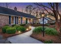 Inviting brick home featuring a walkway, dark shutters, and manicured front yard at 110 Dunbury Dr, Summerville, SC 29485