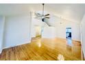 Bright open living room with hardwood floors, cathedral ceiling, staircase access, and modern light fixtures at 112 Mansfield Blvd, North Charleston, SC 29418