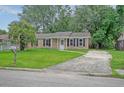 Traditional home with brick facade, black shutters, and a concrete driveway at 112 Pine Grove Dr, North Charleston, SC 29420