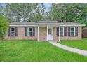 Inviting brick home with manicured lawn and walkway leading to the front door at 112 Pine Grove Dr, North Charleston, SC 29420
