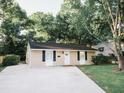 Inviting single-story house featuring a cozy front yard, long driveway, and classic design elements at 1137 Dickson Ave, Hanahan, SC 29410
