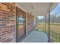 Inviting covered front porch and decorative glass front door entrance to the home at 1186 French Santee Rd, Jamestown, SC 29453