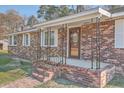 Close-up of brick-paved front porch with sturdy railing and decorative glass front door at 1186 French Santee Rd, Jamestown, SC 29453