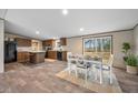A dining and kitchen featuring an island and view of the backyard through a sliding glass door at 1399 Old Whitesville Rd, Moncks Corner, SC 29461